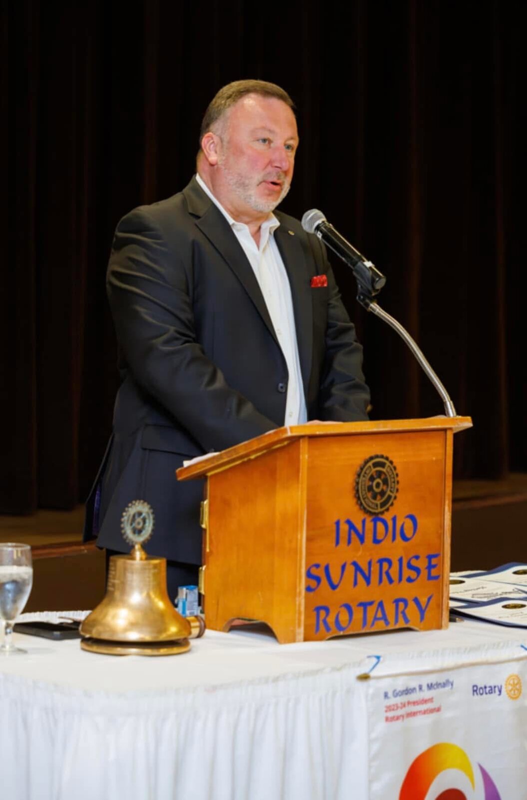 Pete Chryss speaking at the Indio Sunrise Rotary Club podium