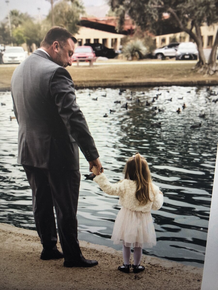 Pete Chryss with his daughter feeding ducks at a local pond